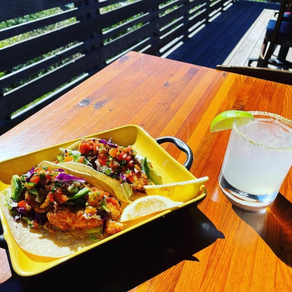 Moonstone Bar & Grill fish tacos with pico de gallo and a margarita on a sunny patio table.